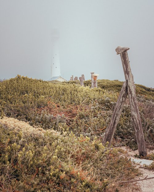 Lighthouse hidden behind the mist in Kommetjie, Cape Town South Africa